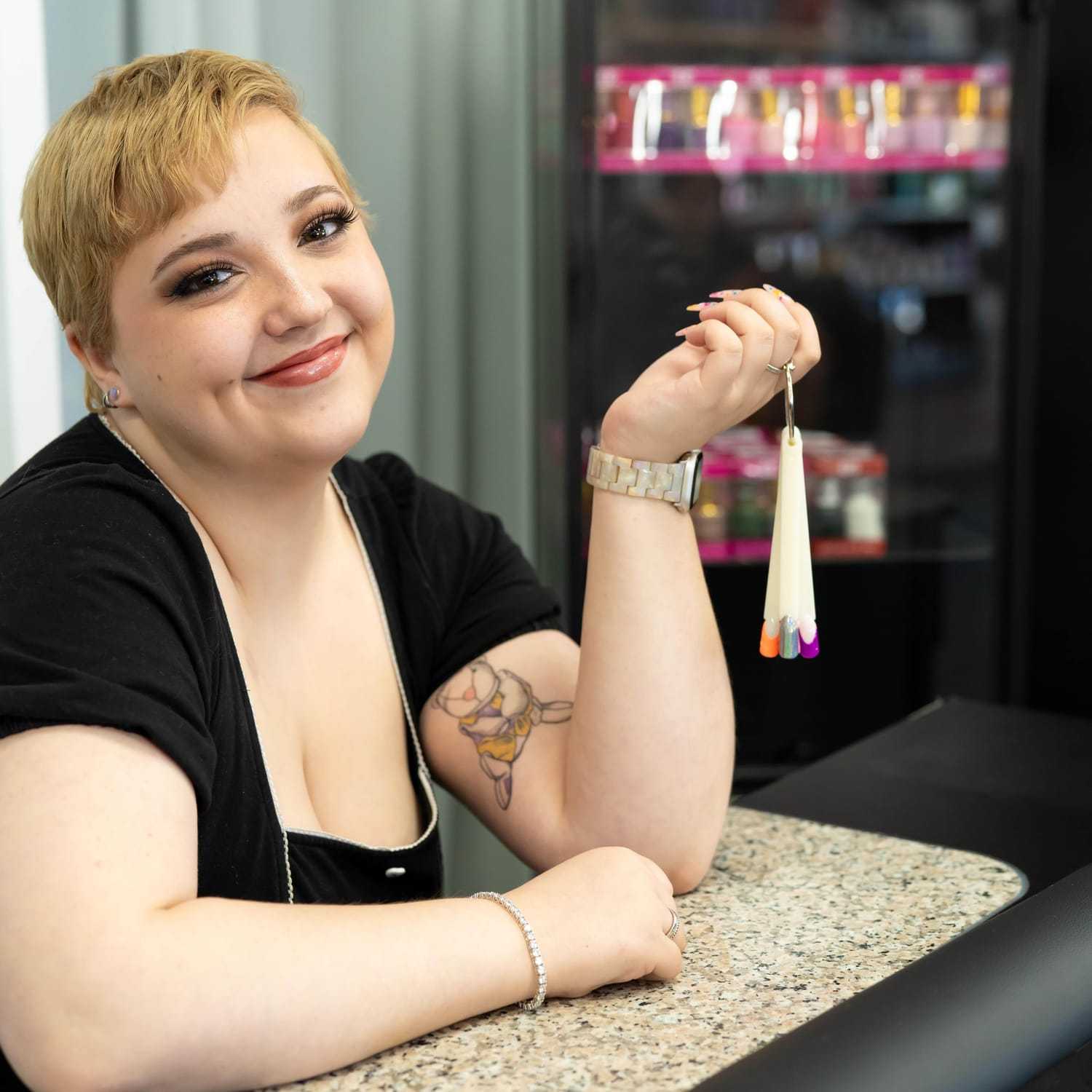 Portrait of Sydney, a professional stylist at Elevate Hair Studio by Tricia Cosgrove, showcasing their expertise and style.