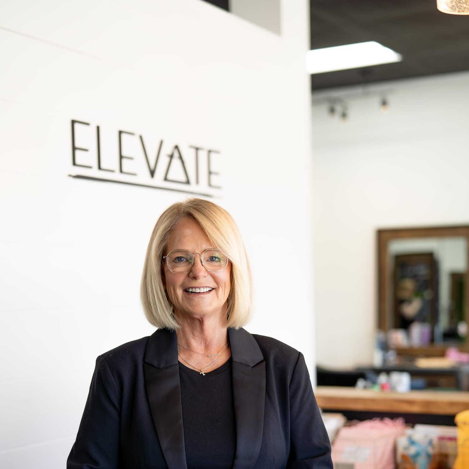 Portrait of Tricia, a professional stylist at Elevate Hair Studio by Tricia Cosgrove, showcasing their expertise and style.