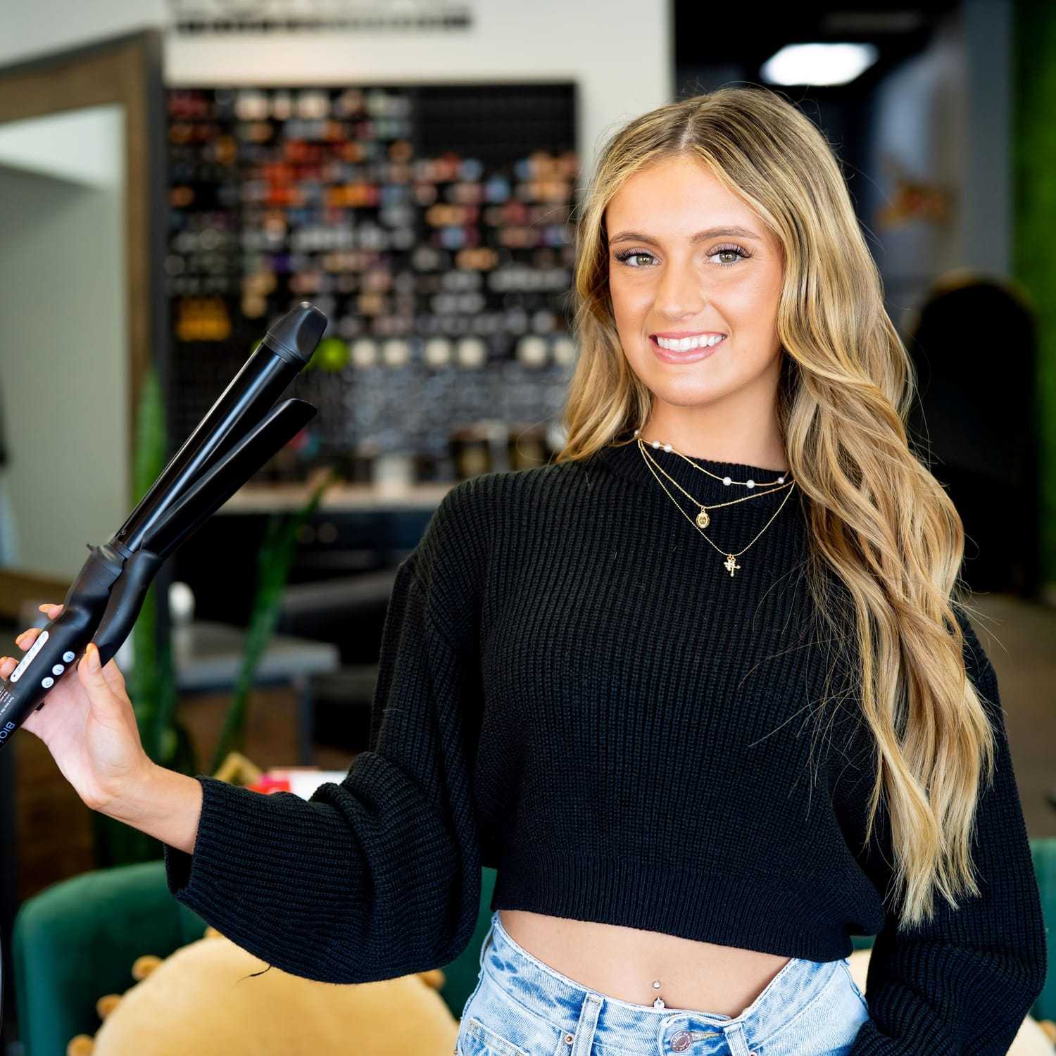 Portrait of Jenna, a professional stylist at Elevate Hair Studio by Tricia Cosgrove, showcasing their expertise and style.