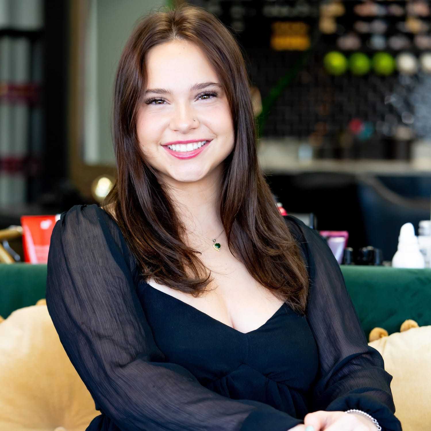 Portrait of Chloe, a professional stylist at Elevate Hair Studio by Tricia Cosgrove, showcasing their expertise and style.